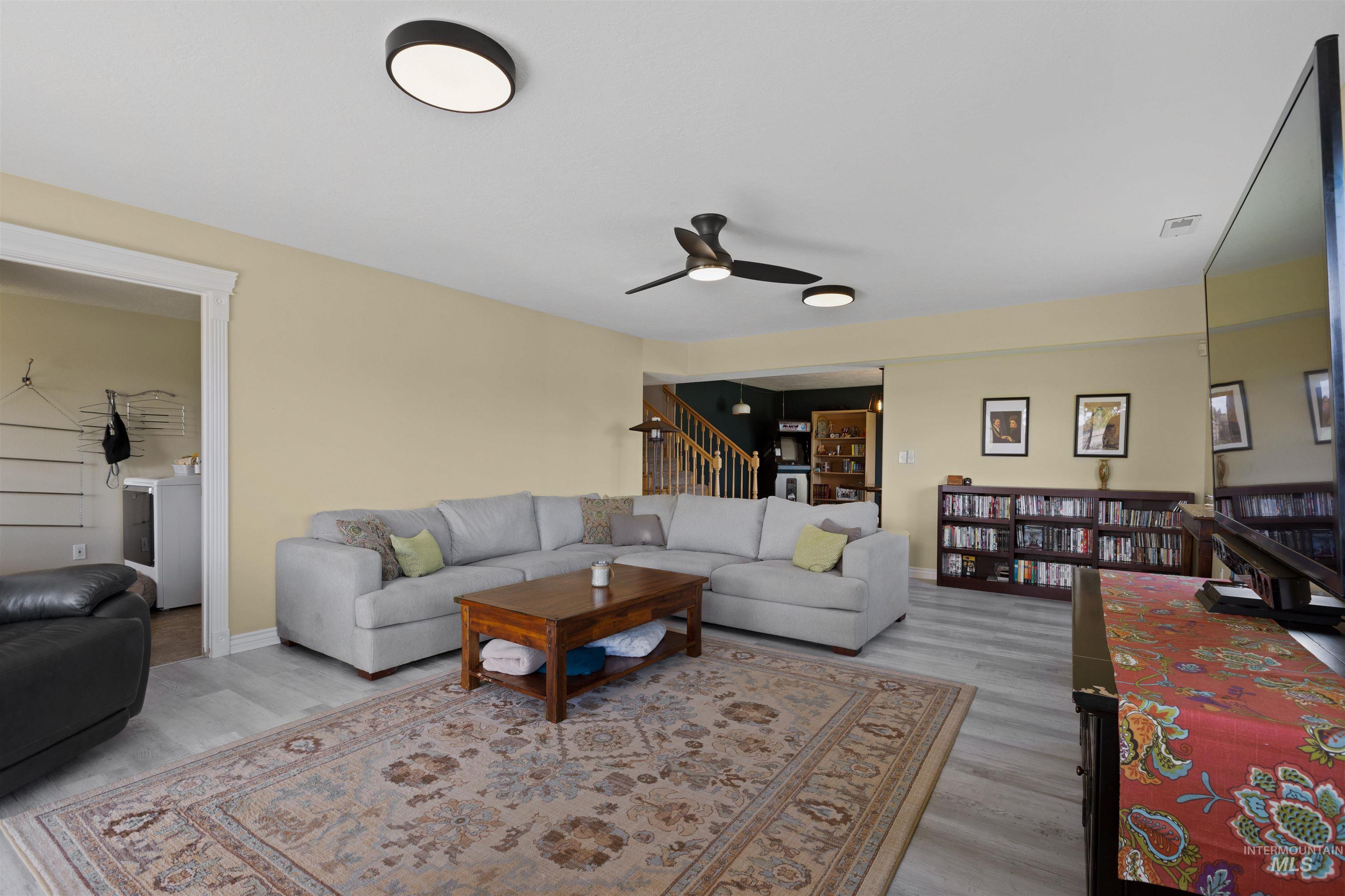 Living room featuring light wood finished floors and a ceiling fan