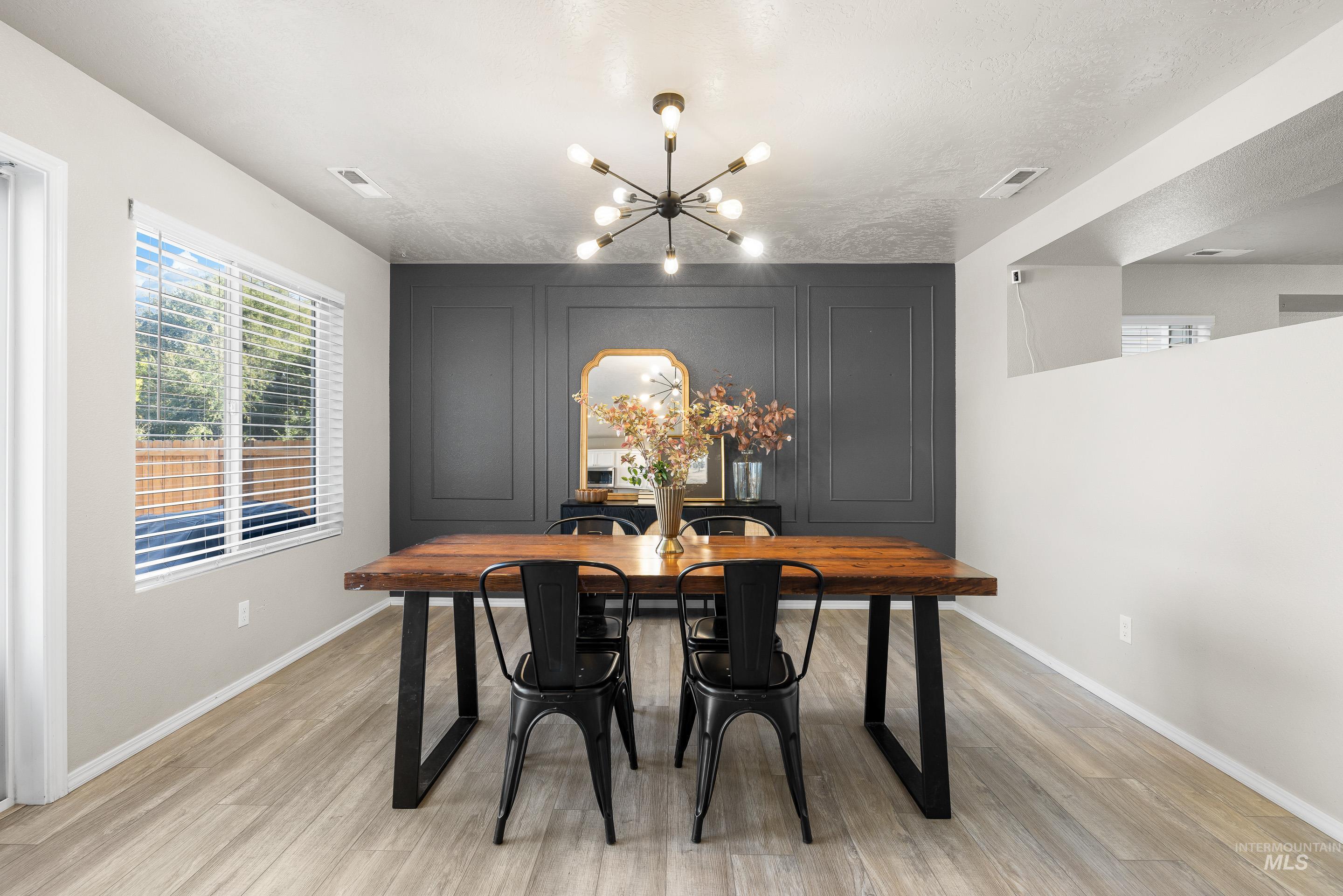 Dining area featuring a chandelier and light wood-style floors