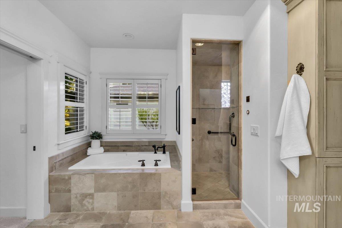 Full bathroom with a garden tub and a stall shower