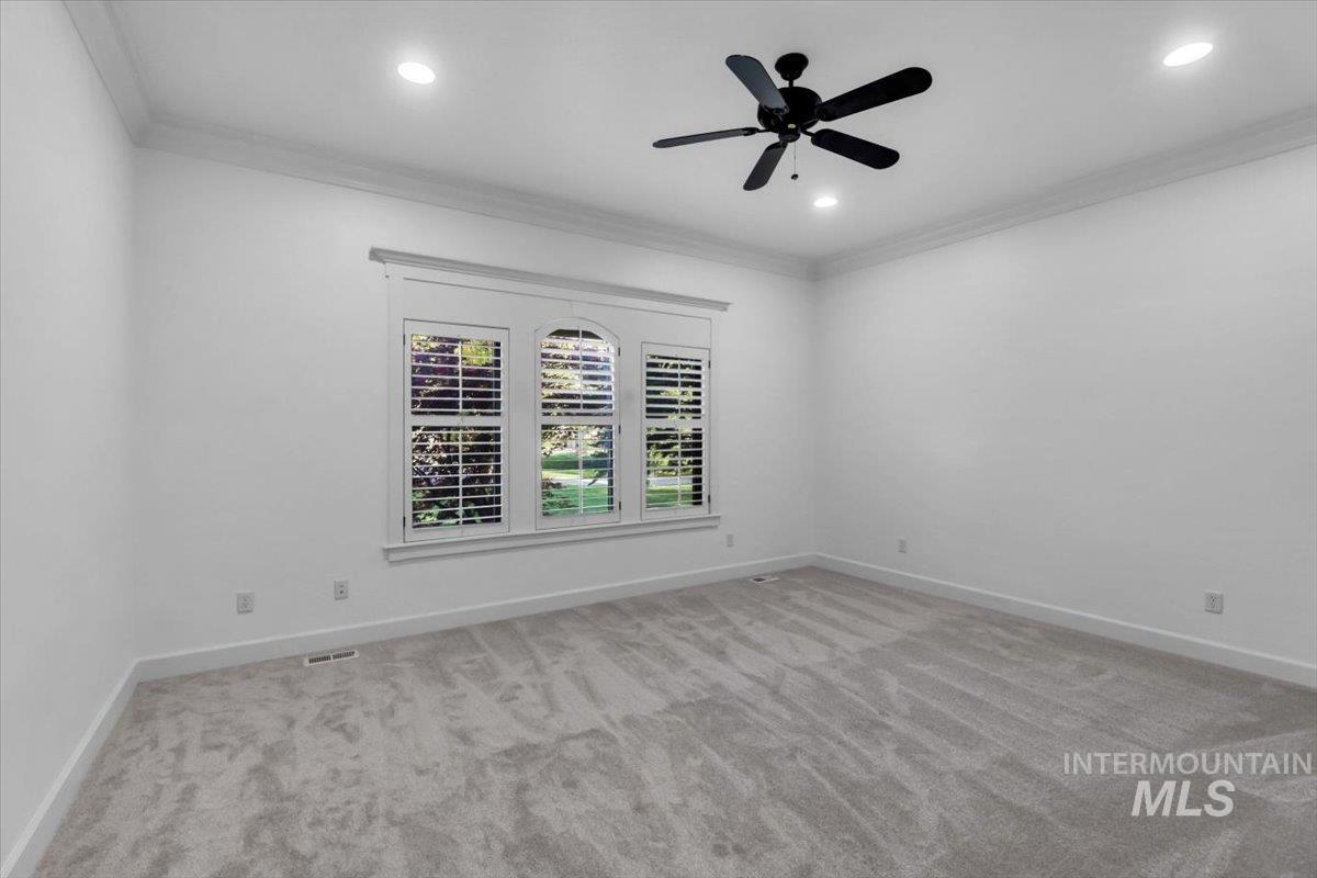 Unfurnished room with crown molding, light carpet, a ceiling fan, and recessed lighting