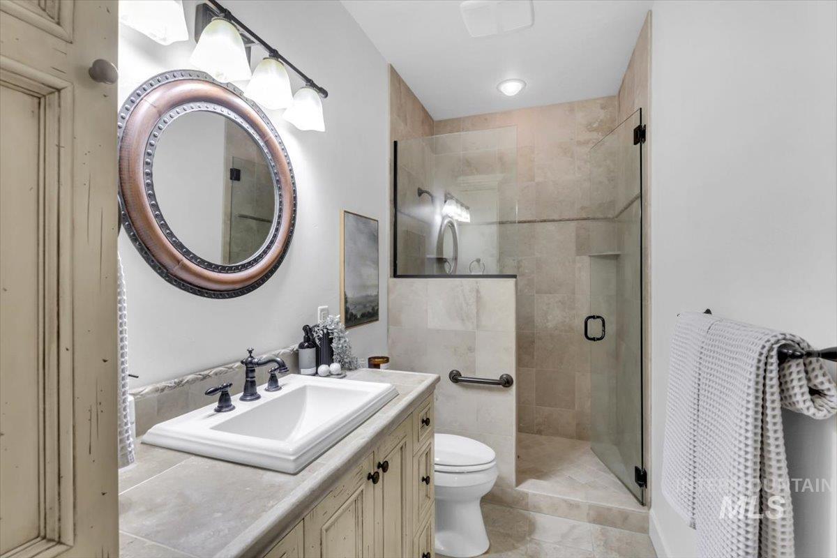 Bathroom featuring vanity and a shower stall