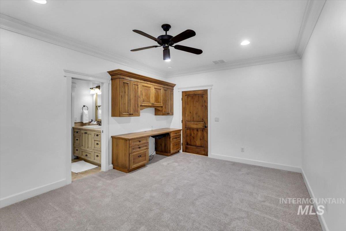 Unfurnished bedroom with crown molding, light carpet, a ceiling fan, recessed lighting, and connected bathroom