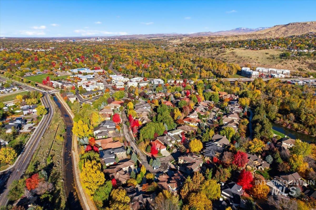 Aerial view of property and surrounding area with nearby suburban area