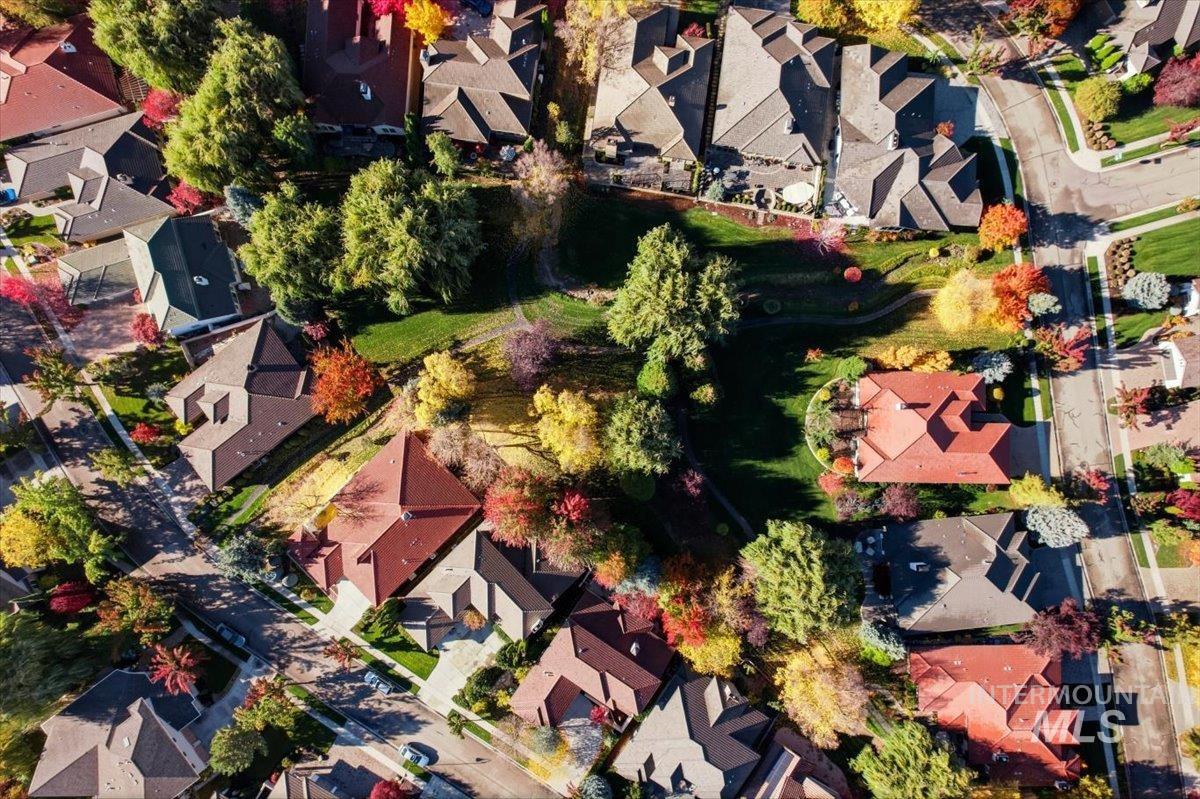 Aerial view of property and surrounding area with nearby suburban area