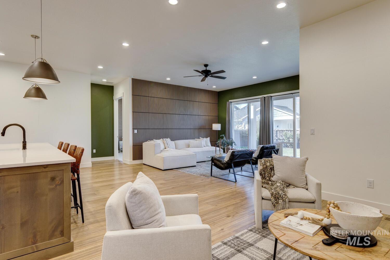 Living room with recessed lighting, light wood finished floors, and ceiling fan