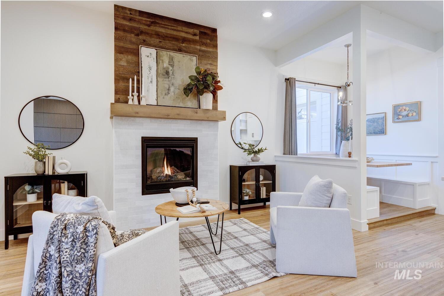 Living room featuring light wood finished floors, a fireplace, and recessed lighting