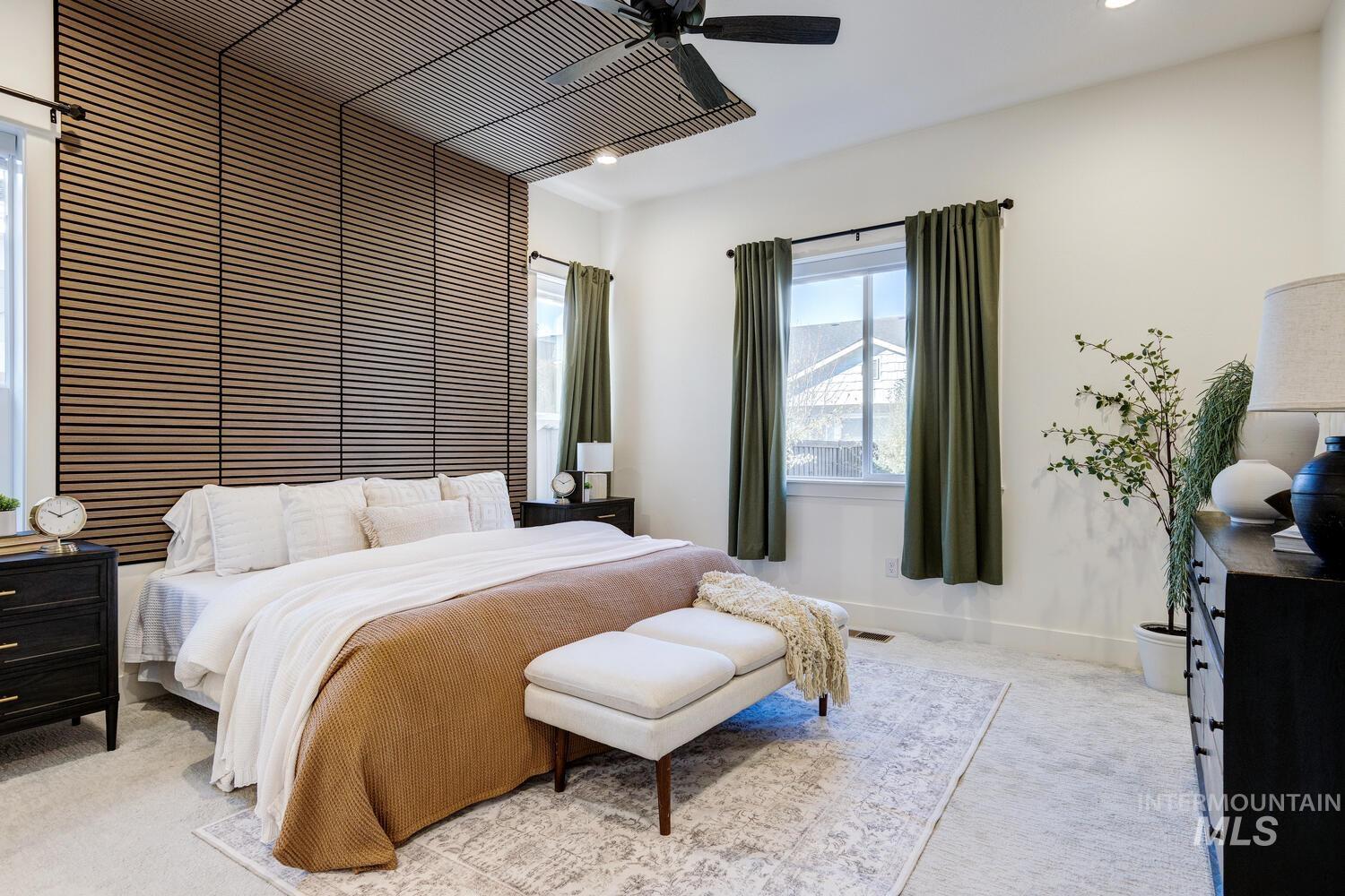 Carpeted bedroom with ceiling fan and recessed lighting