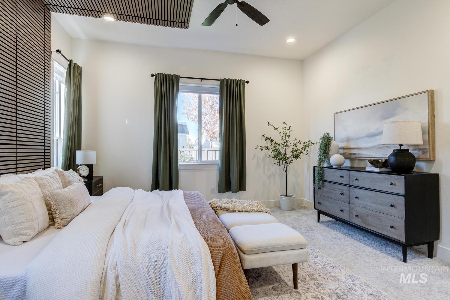 Carpeted bedroom featuring recessed lighting and ceiling fan