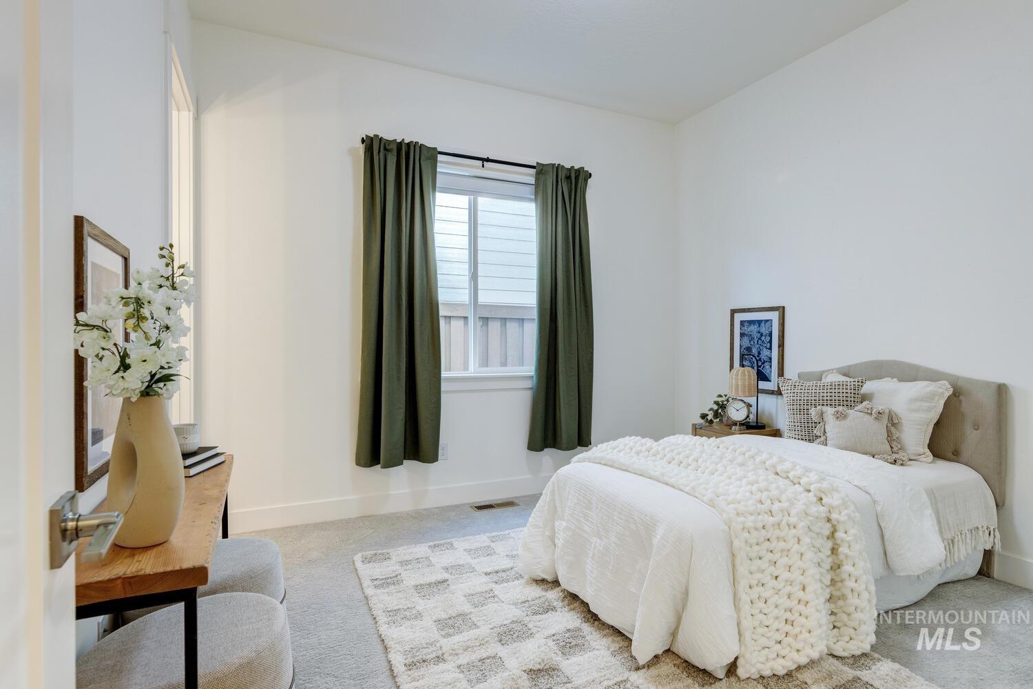 Bedroom featuring carpet flooring and baseboards