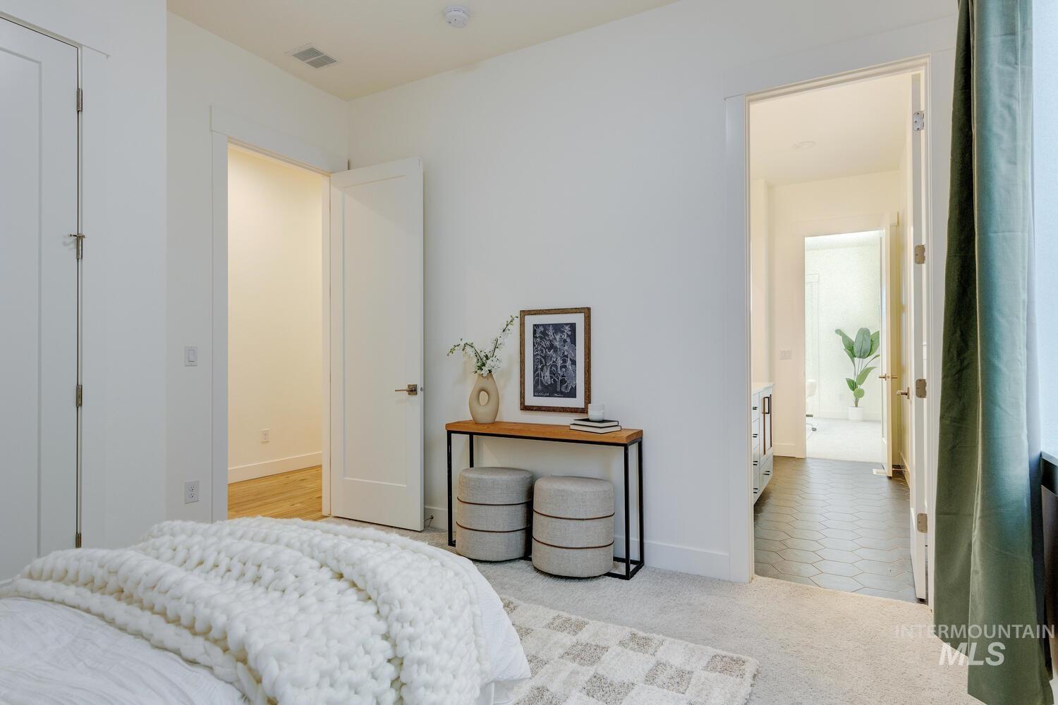 Bedroom featuring light carpet and light tile patterned floors