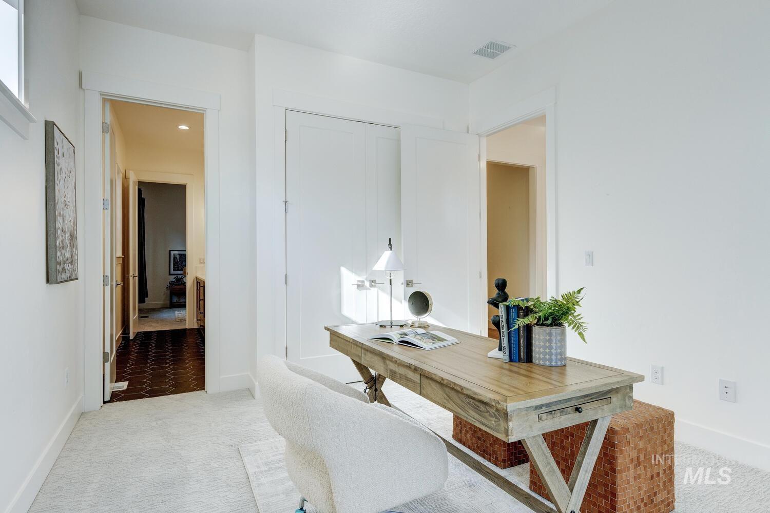 Office space featuring light colored carpet