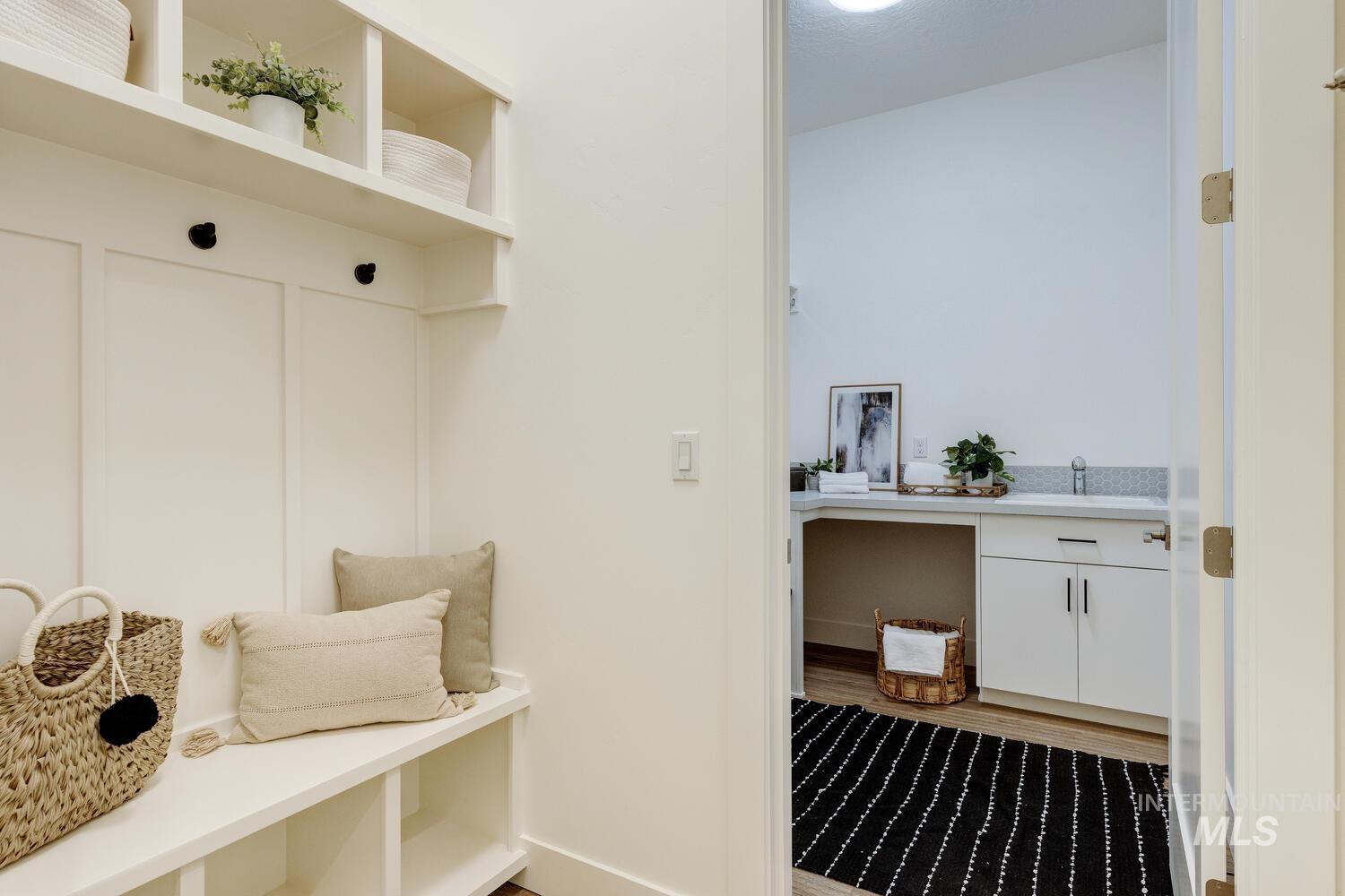 Mudroom with light wood-style flooring and a sink