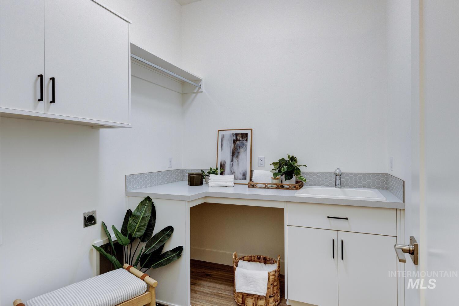 Home office featuring a sink and light wood-type flooring