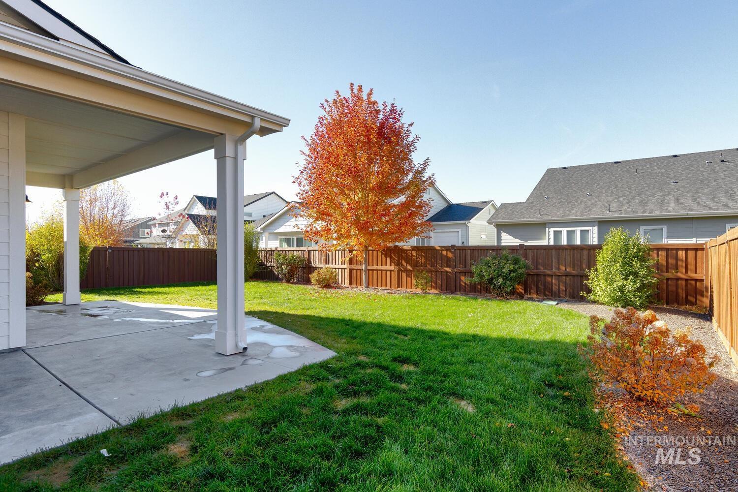 Fenced backyard featuring a patio and a residential view