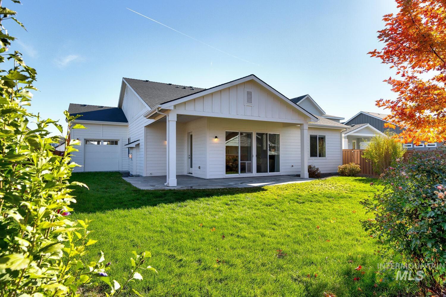 Back of property featuring a patio area and board and batten siding