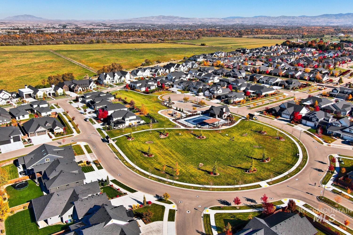 Aerial overview of property's location featuring a mountainous background and nearby suburban area