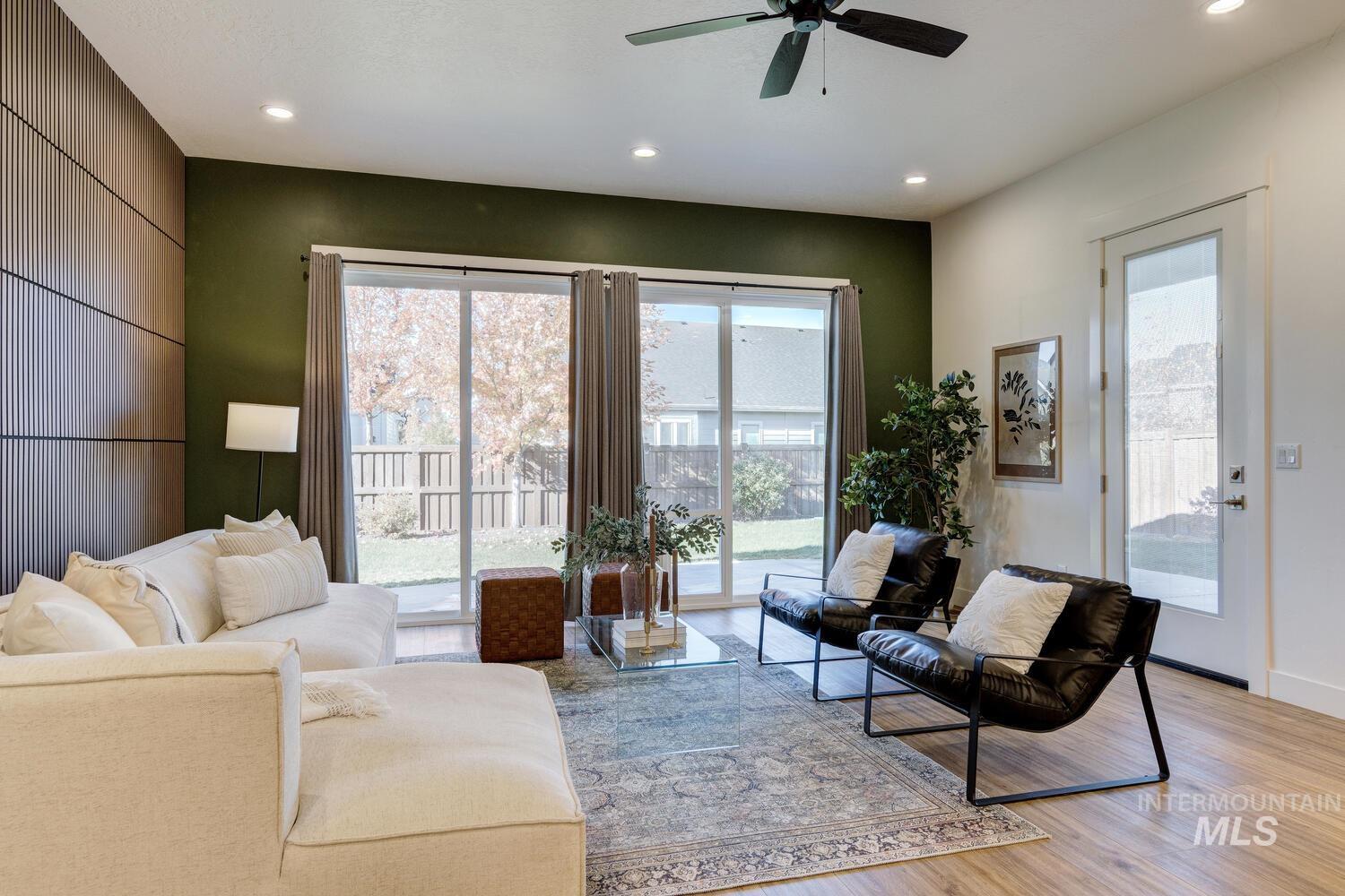Living room featuring light wood-type flooring, recessed lighting, and ceiling fan