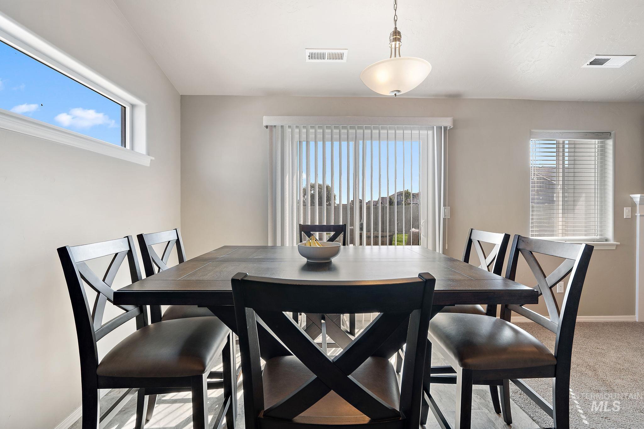 Dining area with baseboards and light carpet