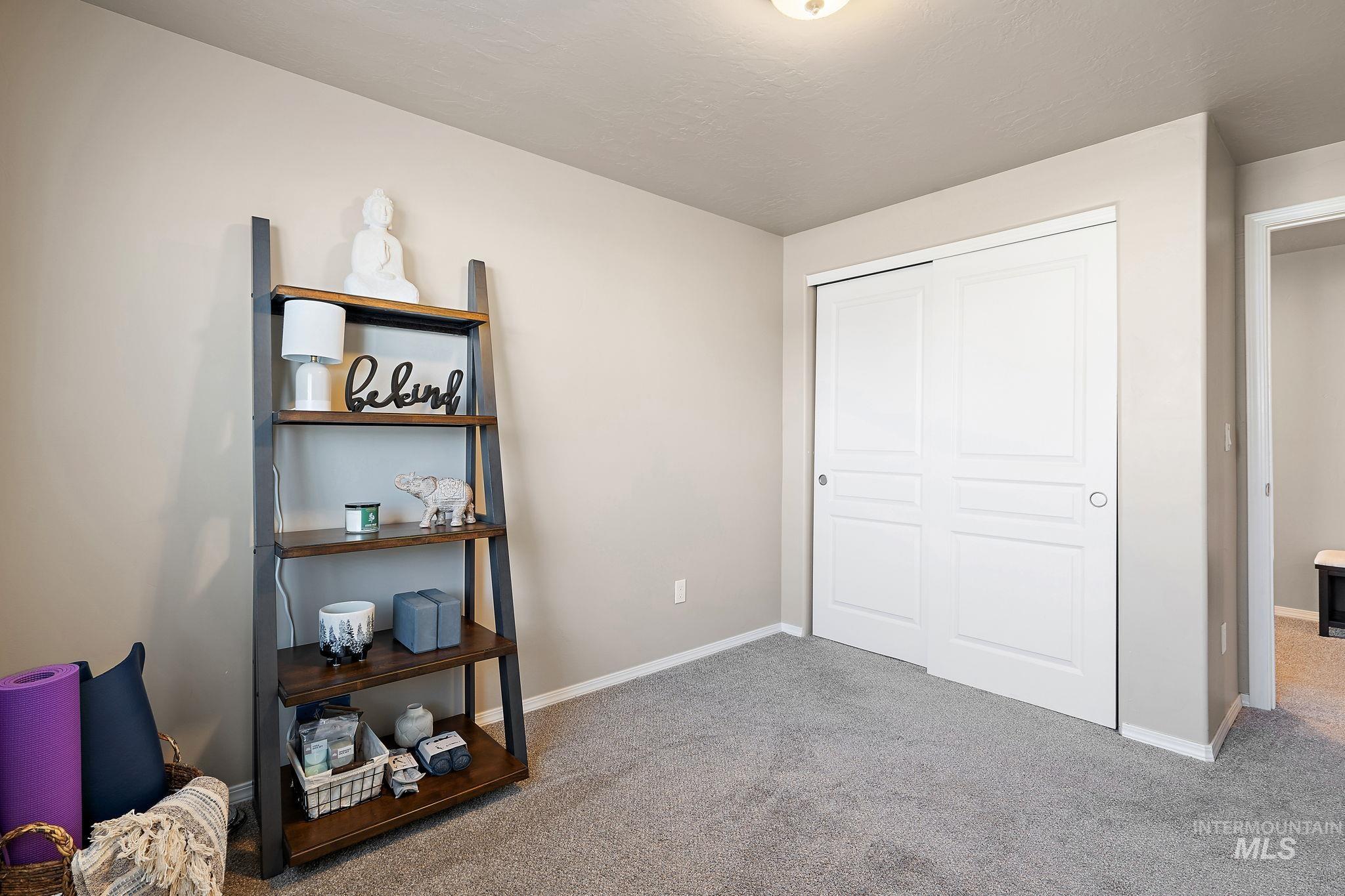 Unfurnished bedroom with light carpet and a closet