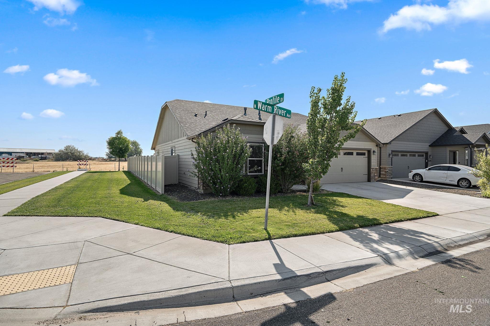View of front of property featuring driveway and an attached garage