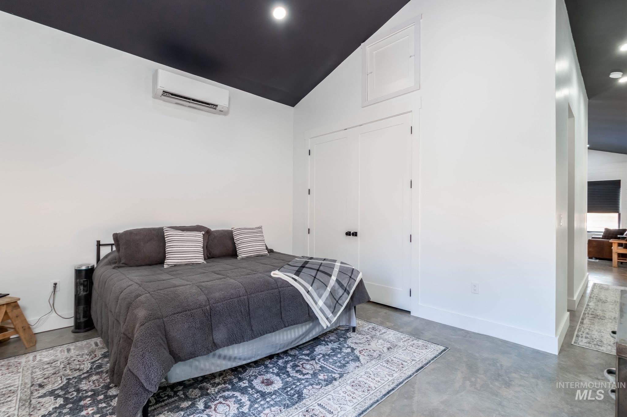 Bedroom featuring concrete floors and recessed lighting