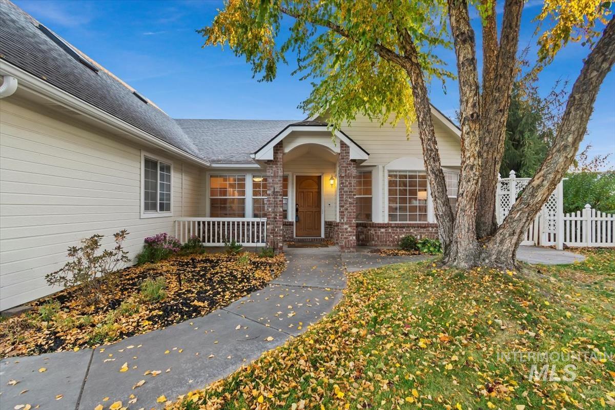 View of exterior entry with brick siding and a shingled roof
