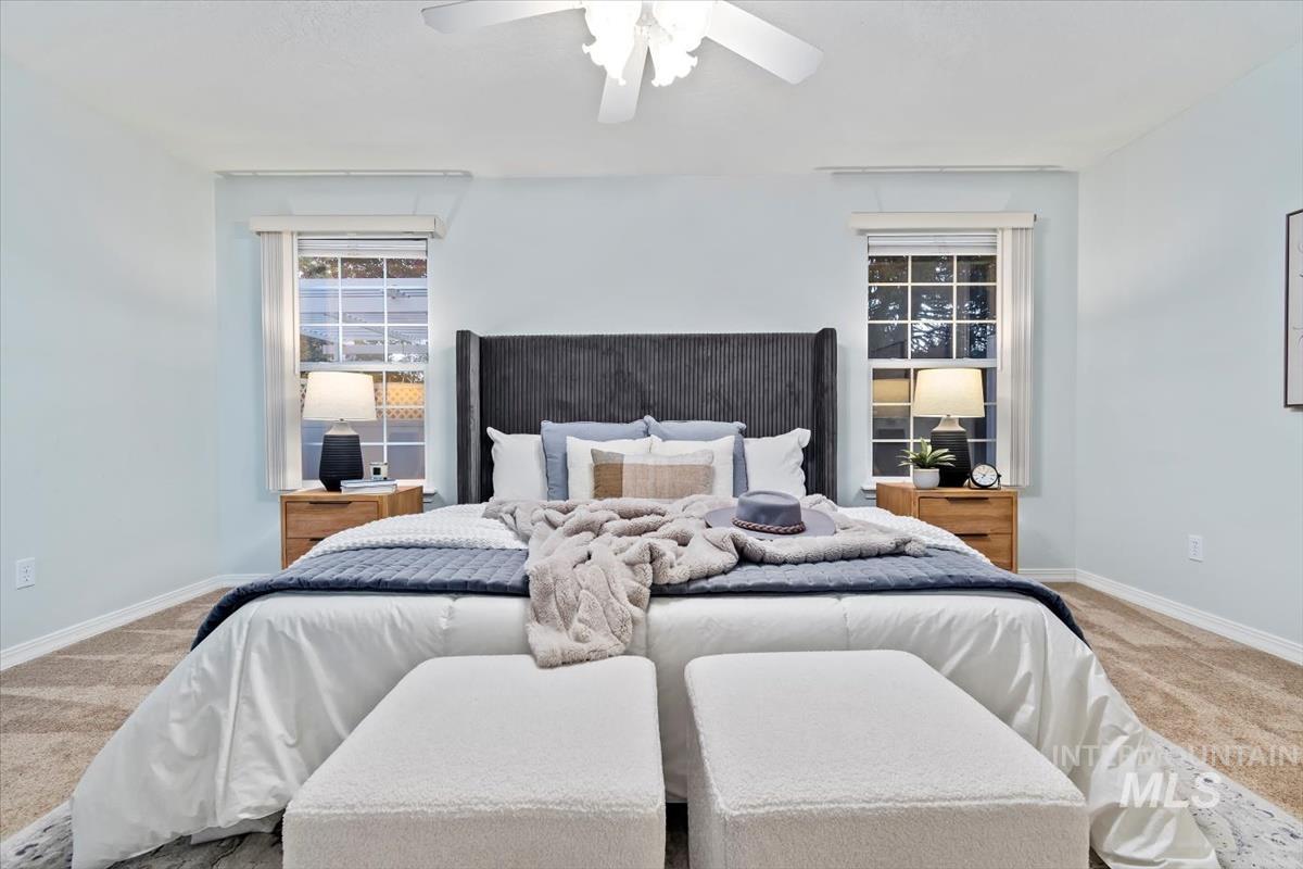 Bedroom featuring light colored carpet and a ceiling fan