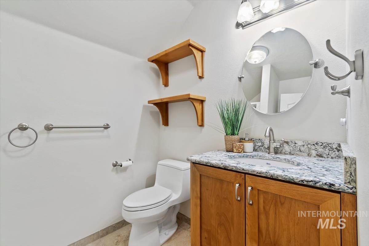 Half bathroom featuring vanity and light tile patterned floors