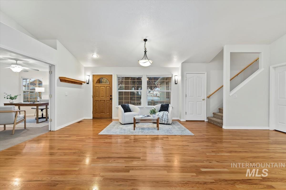 Sitting room featuring stairs and light wood-style flooring