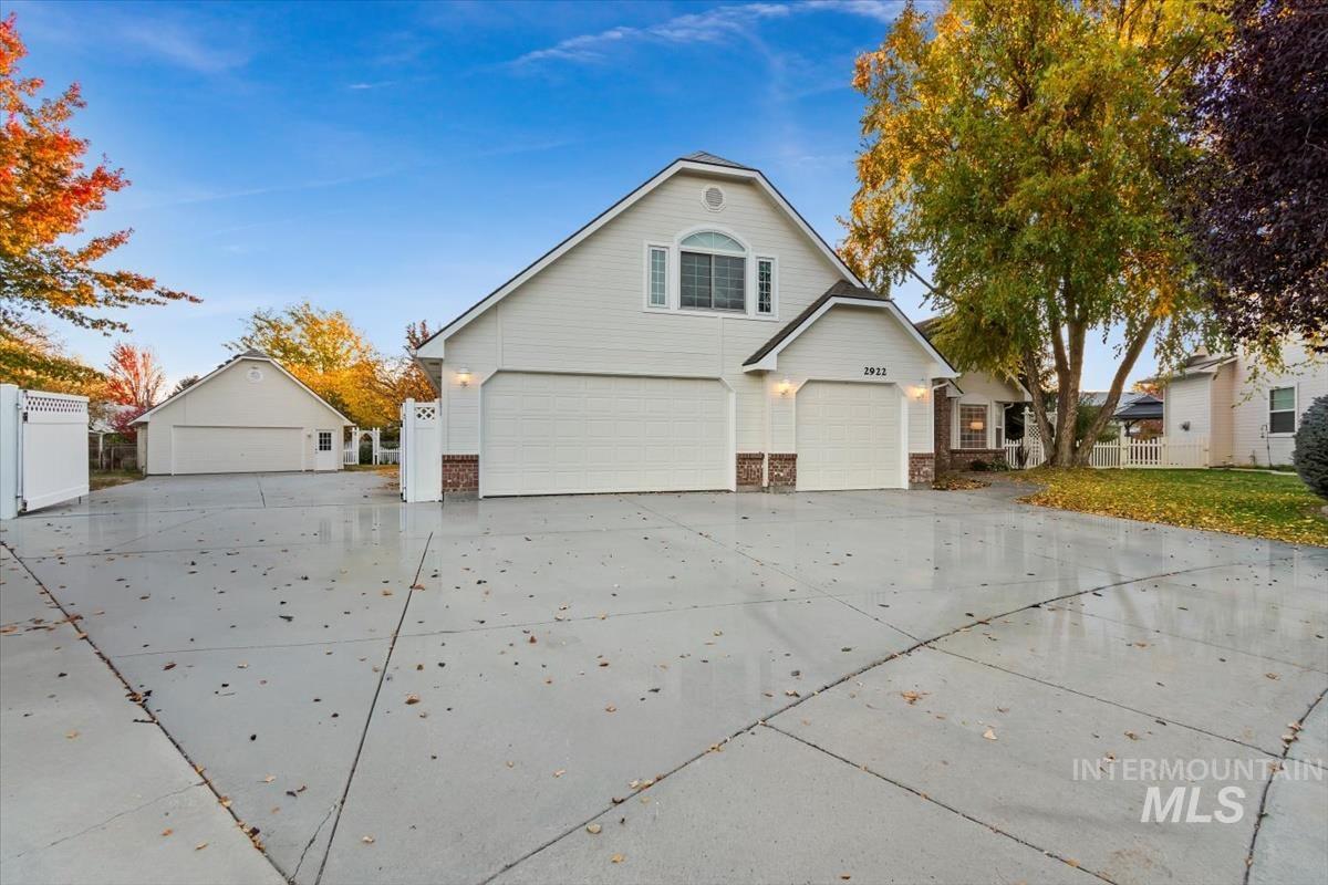 Traditional-style house featuring a garage and driveway