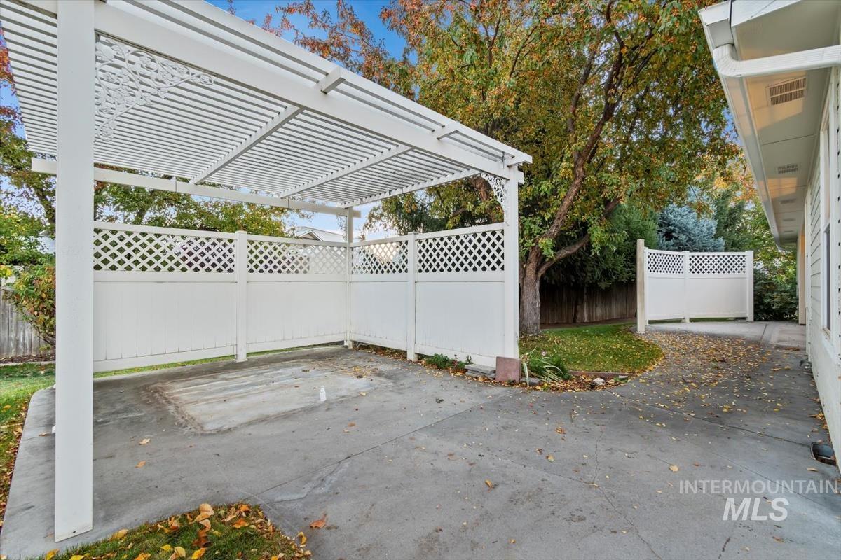 Fenced backyard with a patio area and a pergola
