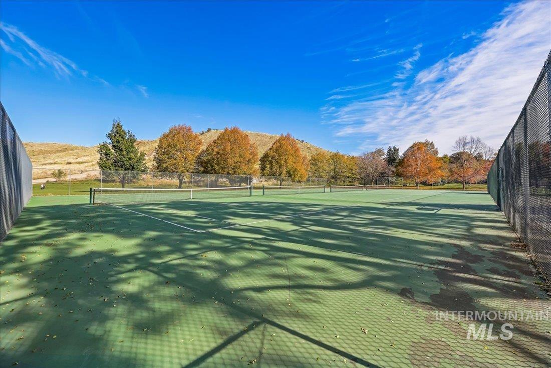View of tennis court with a mountain view