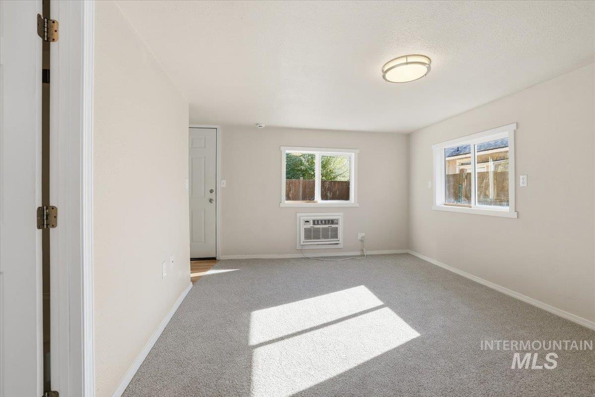 Carpeted spare room with baseboards