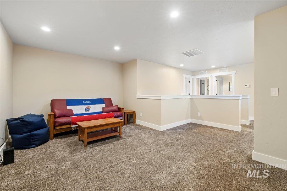 Sitting room with carpet floors and recessed lighting