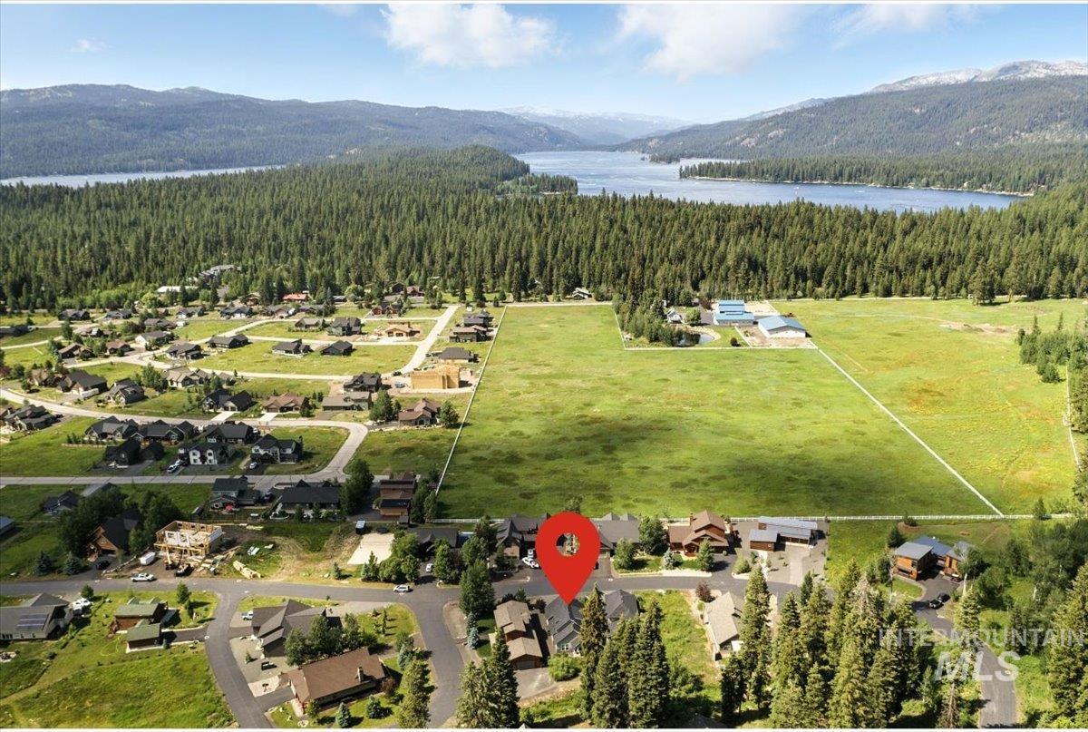 Aerial view of a heavily wooded area and a water and mountain view