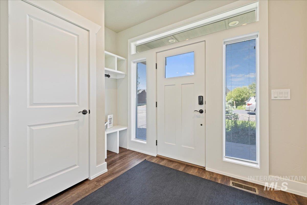 Foyer entrance with dark wood-type flooring