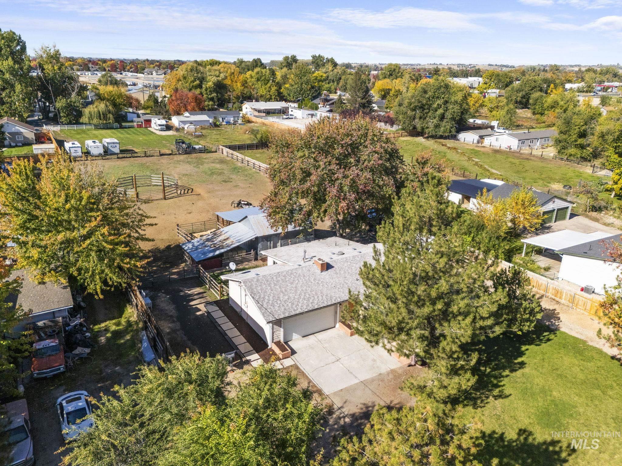 Aerial view of sparsely populated area with a tree filled landscape