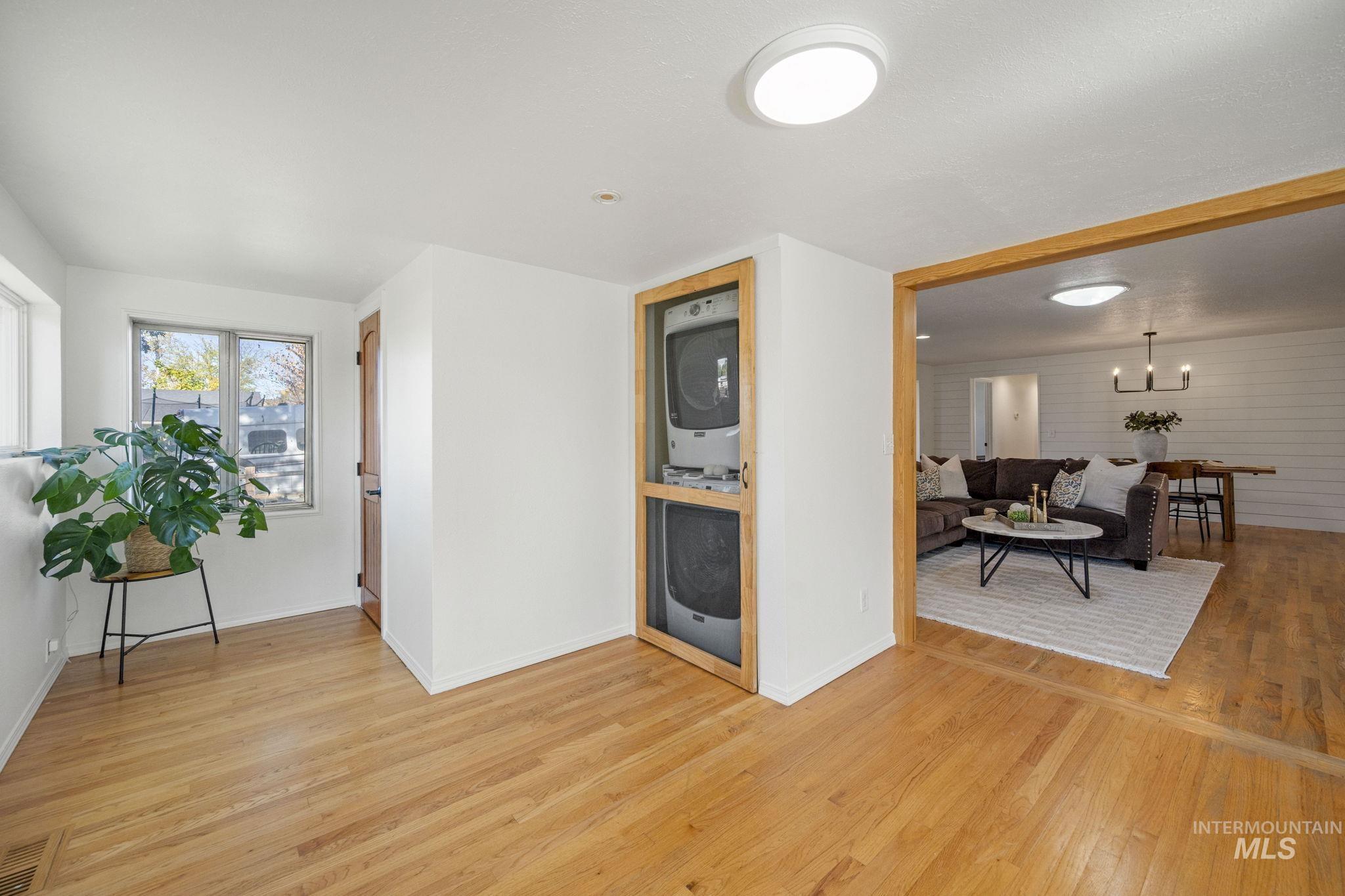 Living room with light wood finished floors and a chandelier