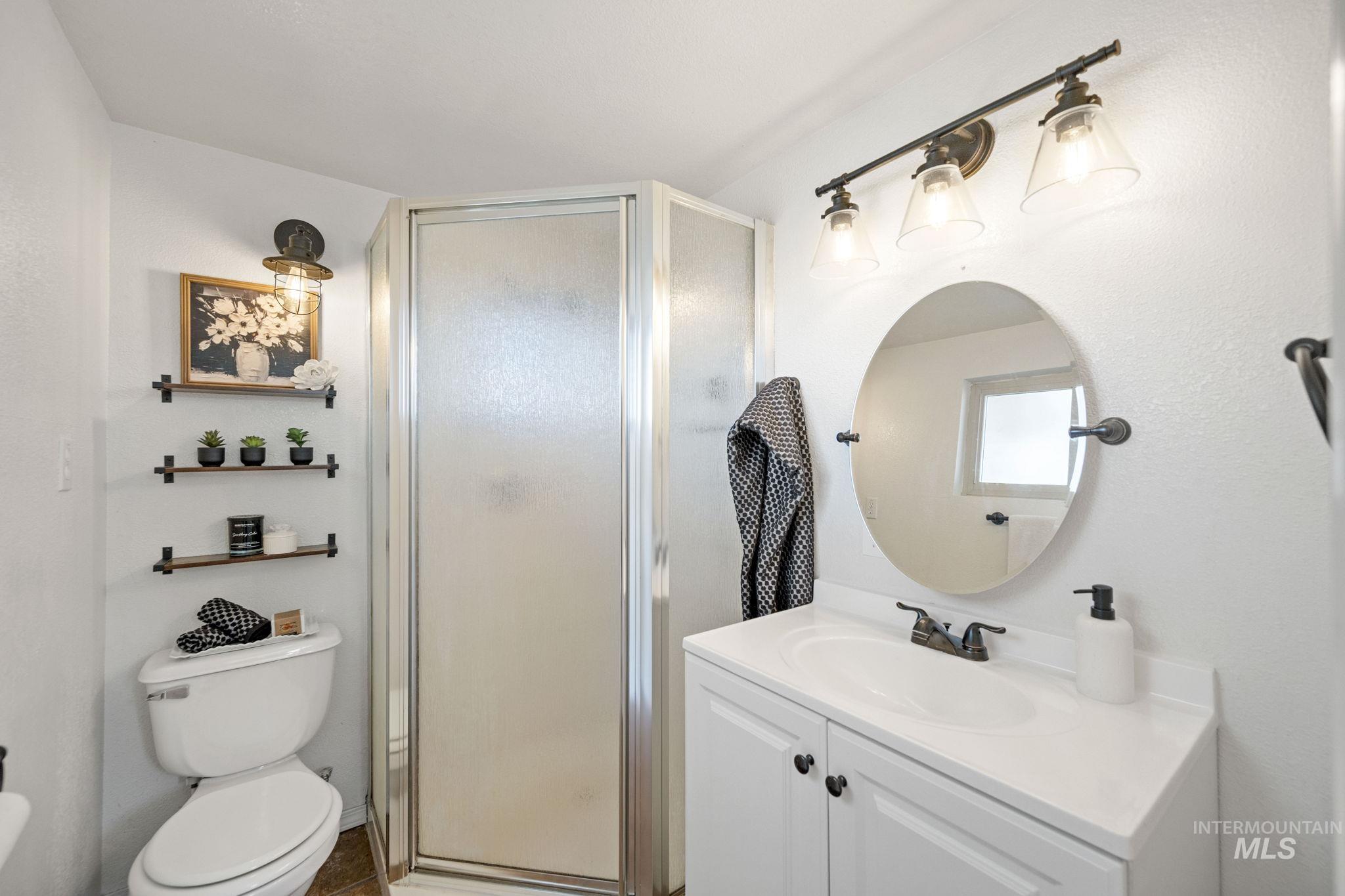 Bathroom with vanity and a shower stall