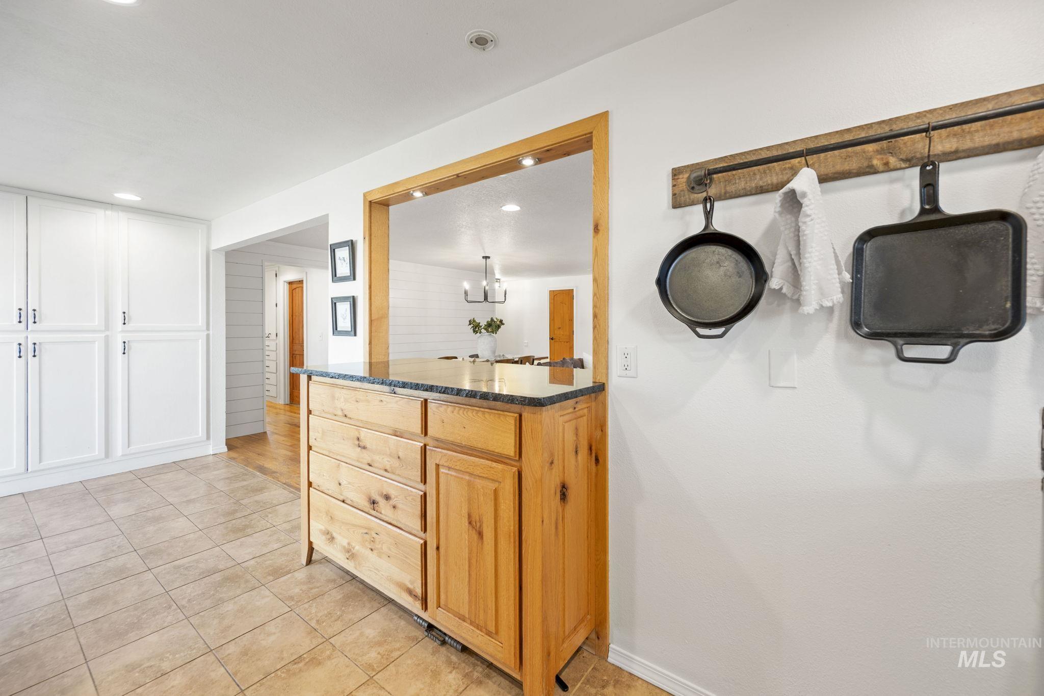 Full bathroom featuring light tile patterned flooring, recessed lighting, vanity, and a chandelier