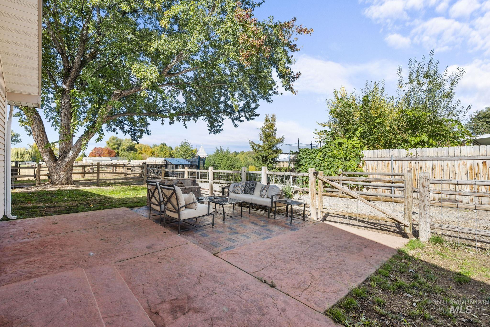 Fenced backyard featuring an outdoor hangout area and a patio