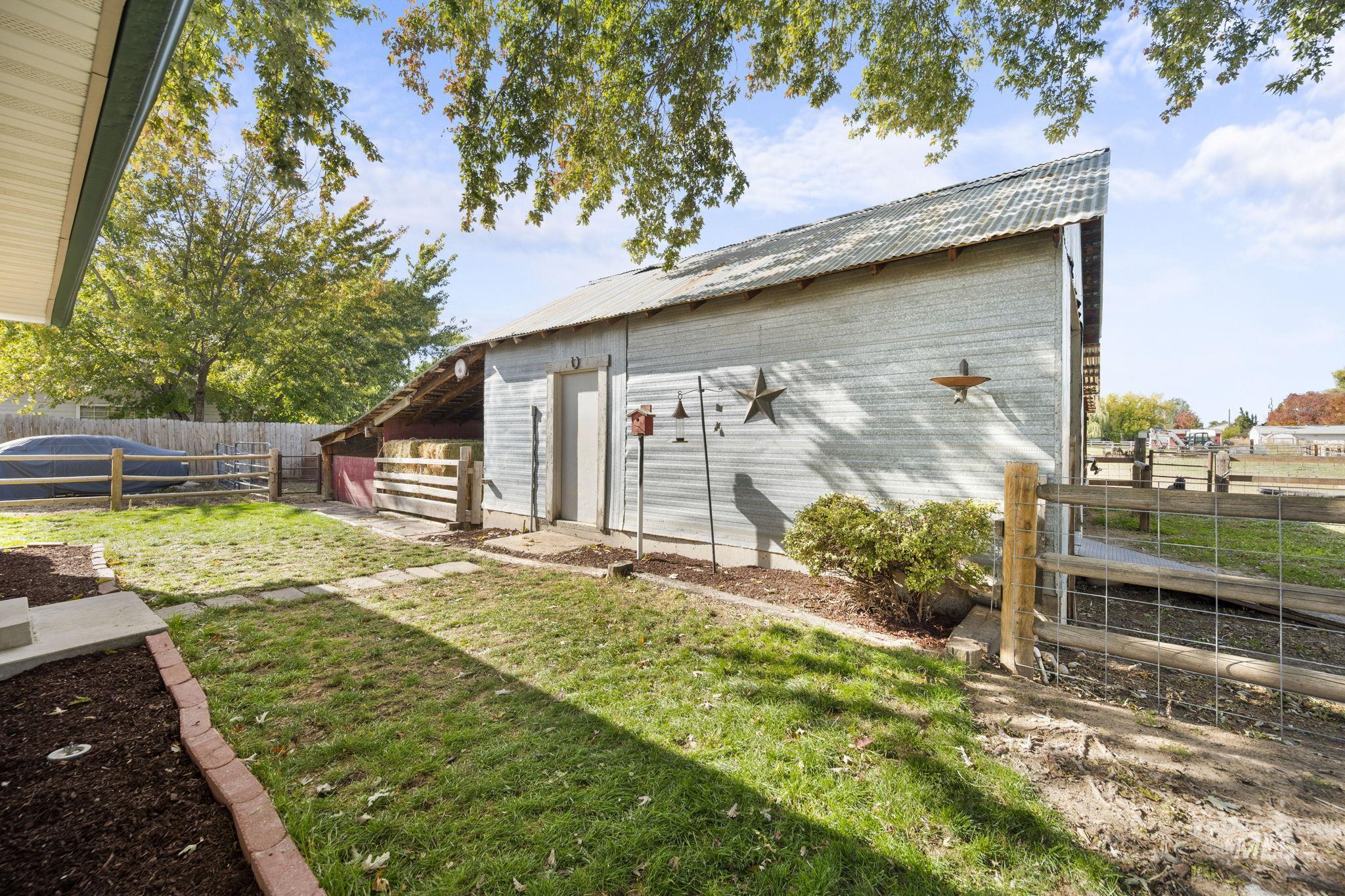 Rear view of property featuring a fenced backyard and a metal roof