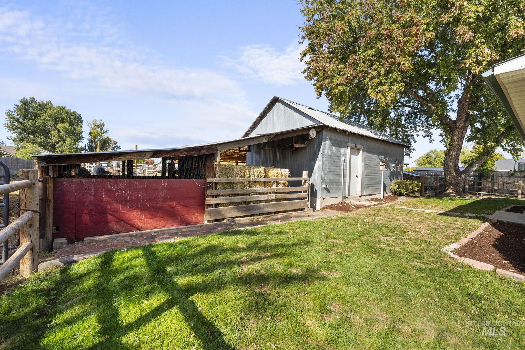 Rear view of house featuring an outbuilding and an exterior structure