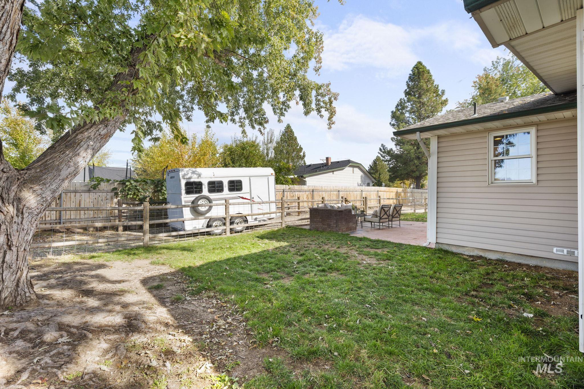 Fenced backyard with an outbuilding and a patio