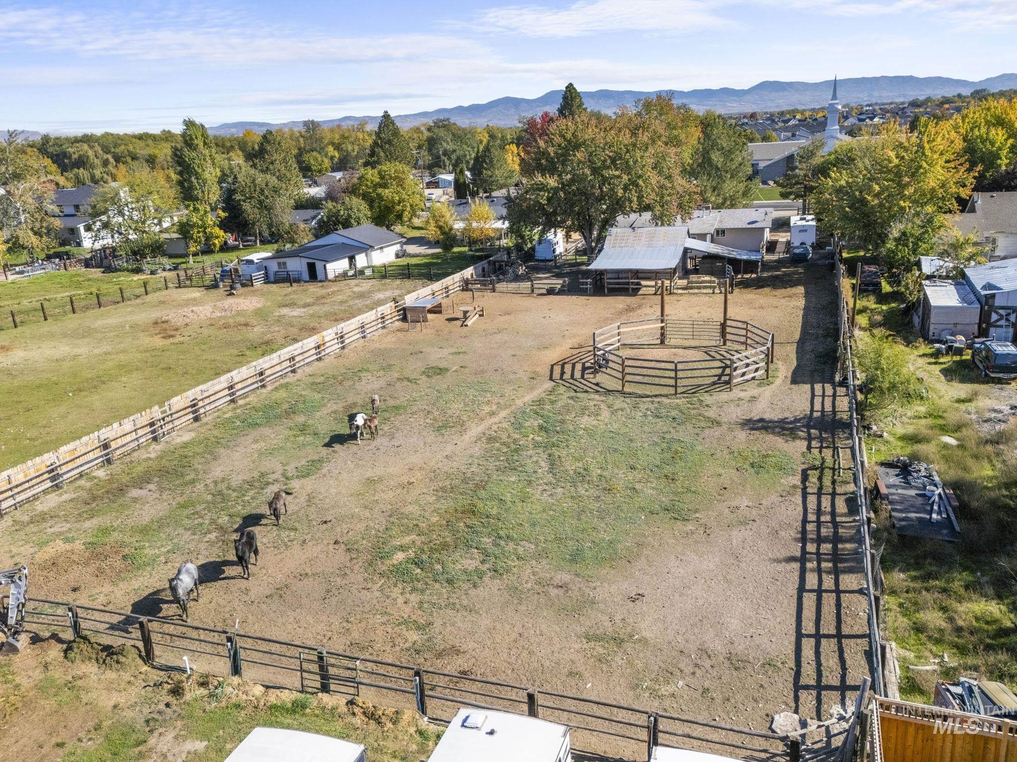 Aerial view of sparsely populated area with agricultural land and mountains