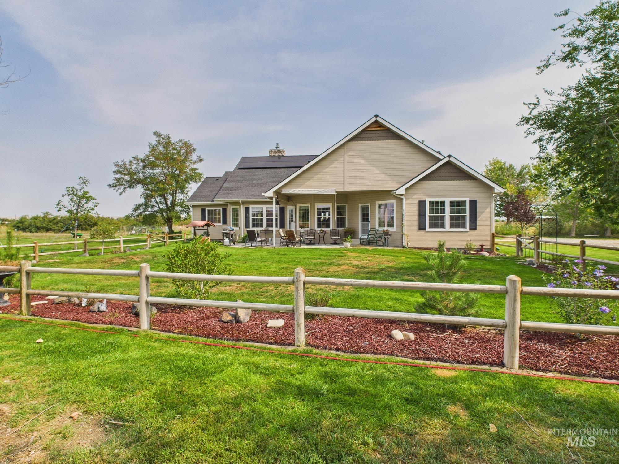 Back of property with a patio and an outdoor living space
