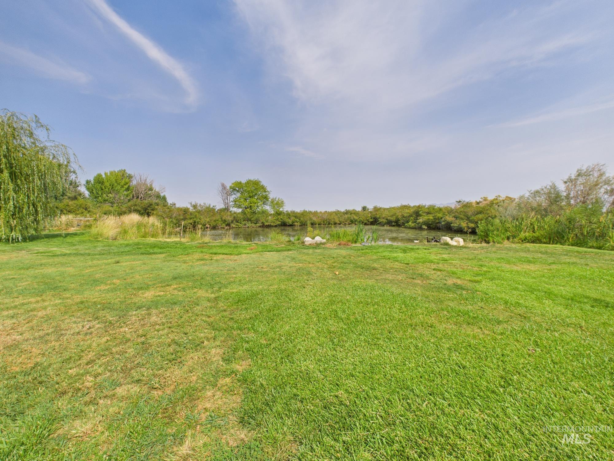View of green lawn with a water view