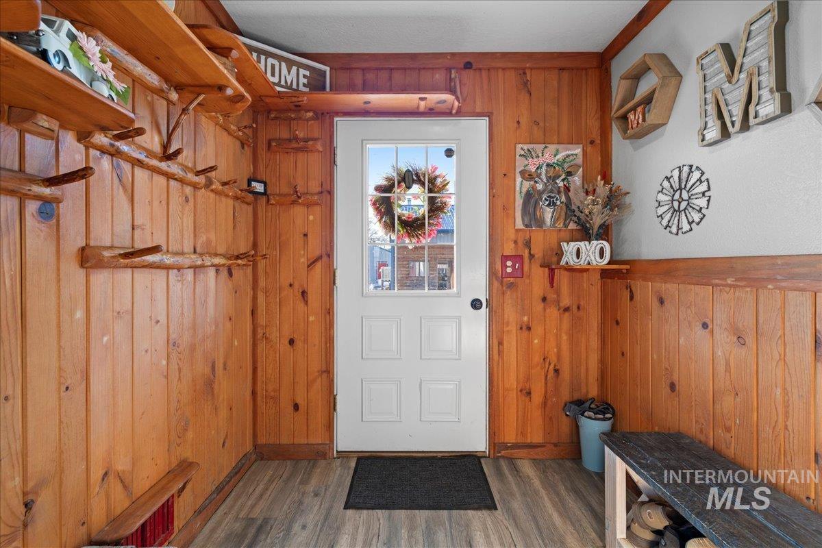 Entryway featuring wood walls and wood finished floors