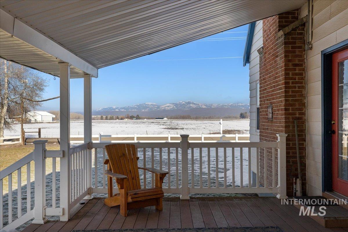 Snow covered deck with a mountain view