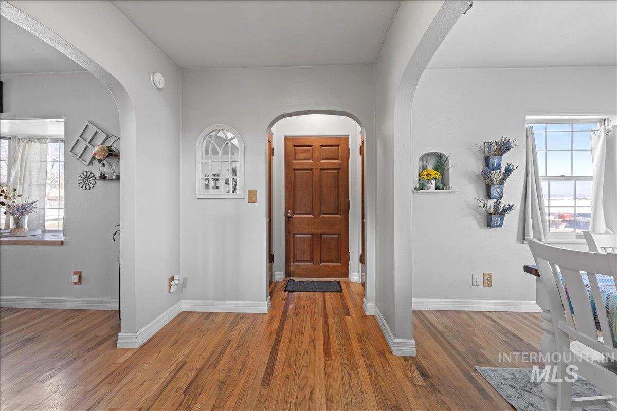 Foyer entrance featuring wood finished floors and baseboards